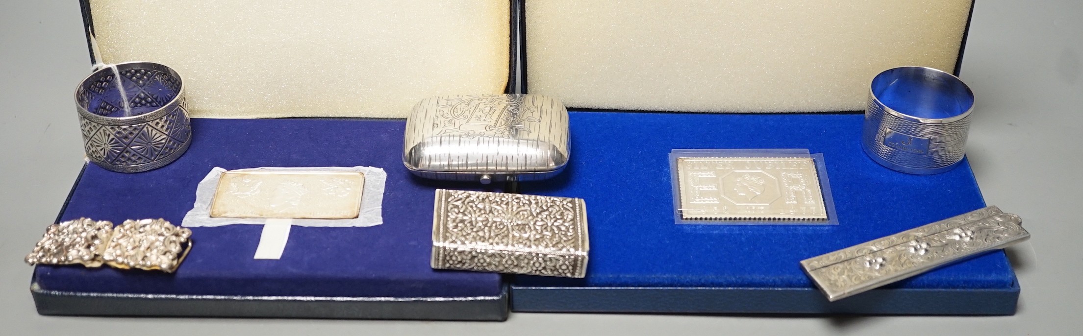 Small silver items including two napkin rings, a modern cased commemorative plaque and replica stamp, together with four white metal items including a Russian mounted purse.